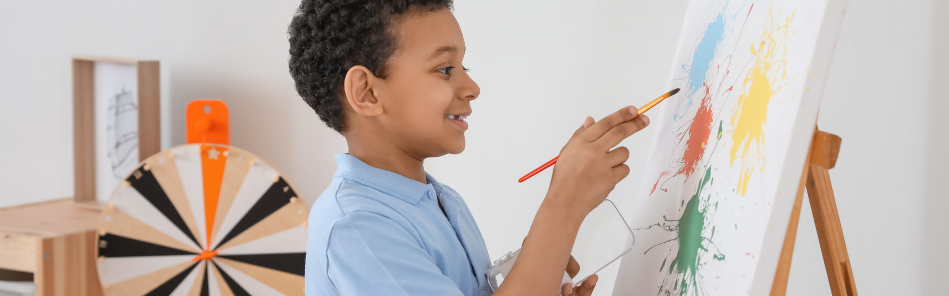 young boy doing painting